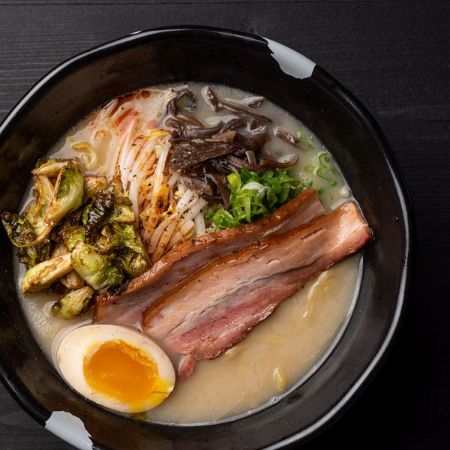 SPROUTING UP RAMEN - pork and chicken broth: pork chashu, kikurage, spicy bean sprouts, green onion, half seasoned egg*, crispy brussels sprouts, black pepper and ginger, served with thick noodles