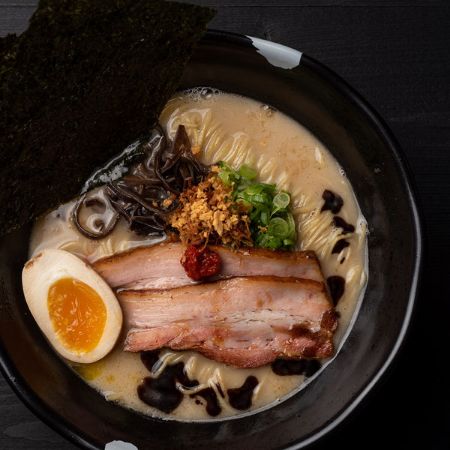 TONKUTSU BLACK RAMEN - pork broth: pork chashu, kikurage, green onion, nori dried seaweed, seasoned egg*, garlic chips, garlic oil, fried onion and spicy sauce, served with thin noodles