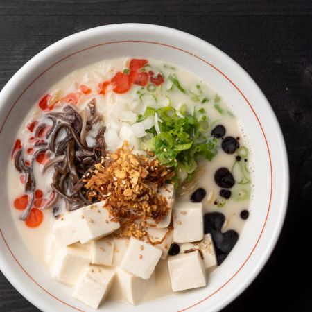 SPICY VEGAN RAMEN - vegetable broth: tofu, onion, green onion, kikurage, crispy onion, garlic chips, garlic oil, chili oil and sesame seeds, served with thick noodles