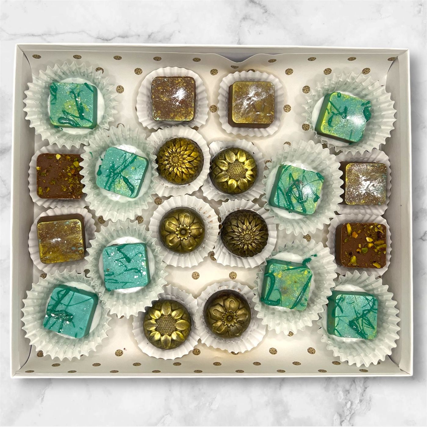 Custom White Chocolate dyed to a Blue/Green Color with Glitter Dust & crushed pistachio bits, Dark Chocolate with Yellow/Gold glitter dust and Milk Chocolate with Yellow/Gold Glitter dust and crushed pistachio bits 