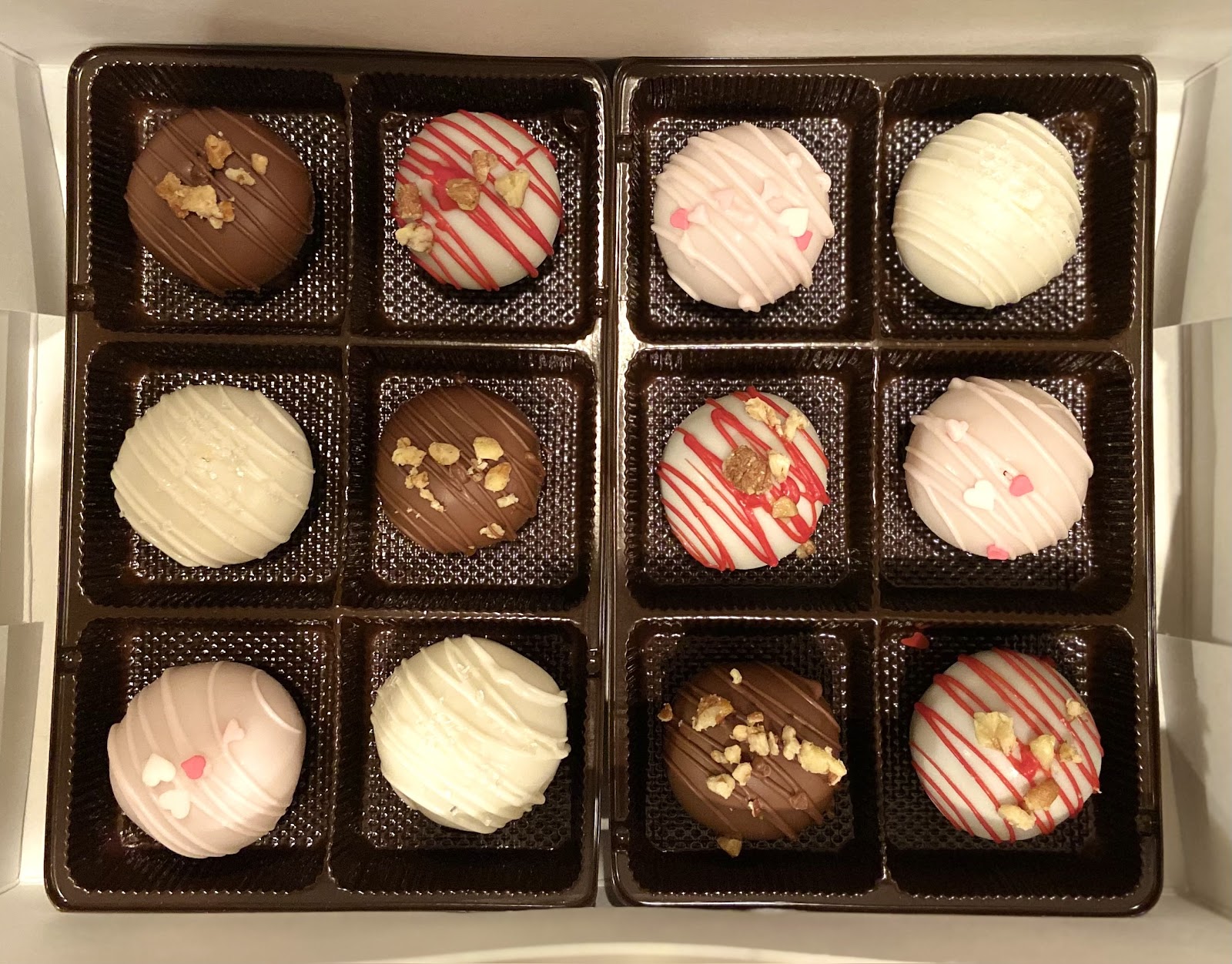 Cake Truffles 
Delicious cake mixed with just enough SugarCains buttercream, rolled into 1 oz balls, and dipped in white or milk chocolate. Flavors are White Wedding, Caramel Pecan Brownie, Strawberry, & Red Velvet. They're seriously good! 