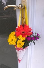 May flower basket - PICK UP. Flower basket is a paper cone filled with a variety of fresh flowers, with a ribbon attached to hang from a door handle. 