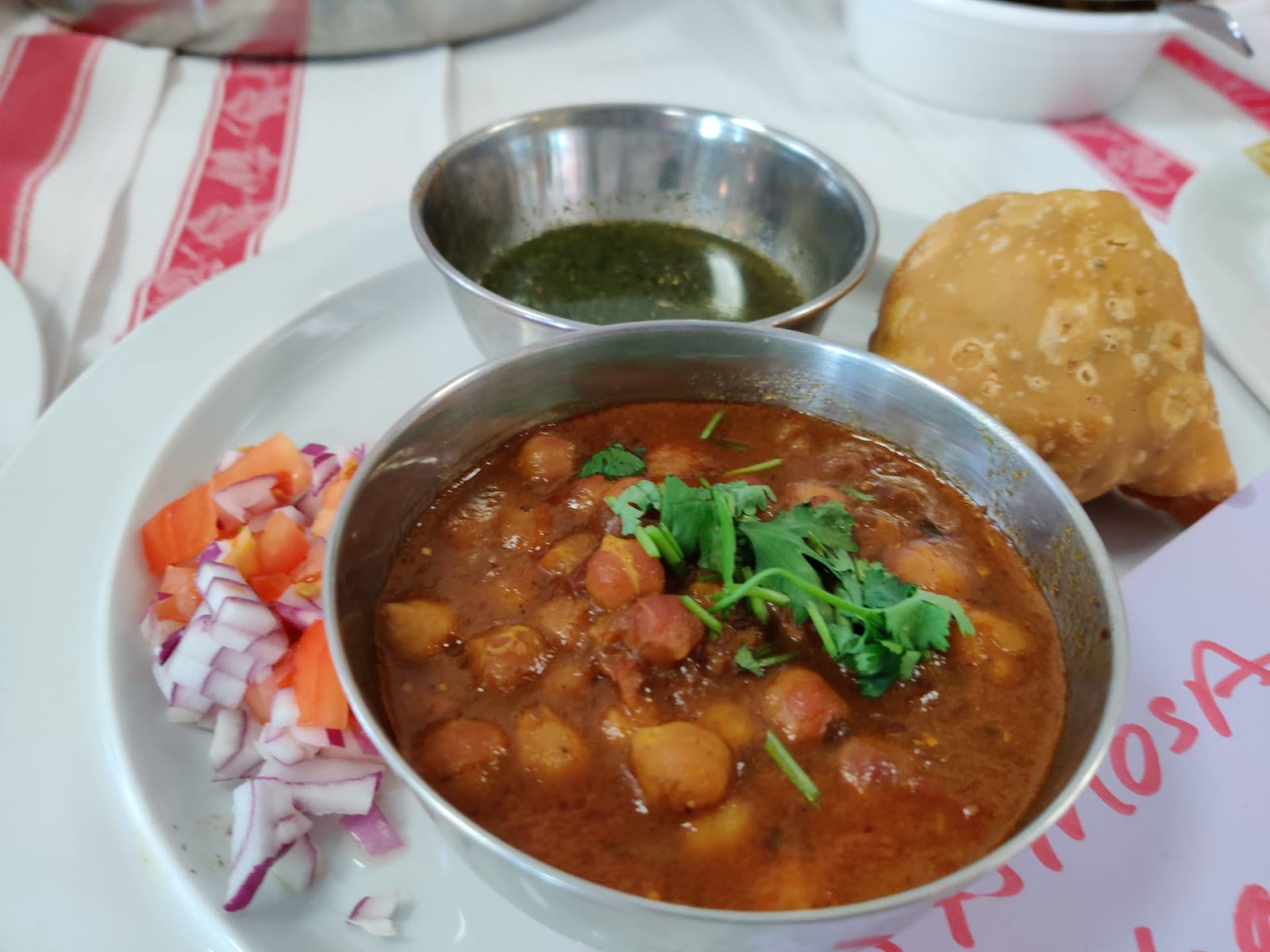 Samosa Chaat: 12 CHF 
Samosa with chick peas gravy garnished with sauces and savory and salad