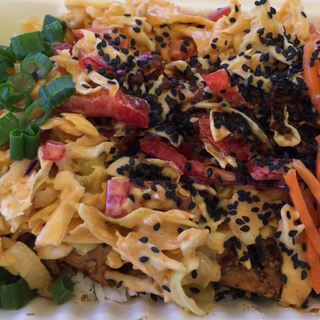 BURNSIDE BOWL - Teriyaki marinated chik'n, roasted garlic cloves, fire breathing dragon sauce, sweet red pepper slaw, carrots, scallions and black sesame seeds on a bed of jasmine rice.