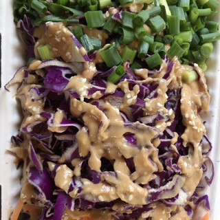 BROADWAY BOWL - Garlic tofu, peanut ginger sauce, cilantro, red cabbage, carrots, scallions and toasted sesame seeds on a bed of jasmine rice.