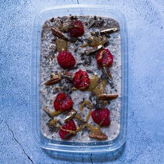 Banana Chia & Oat Protein Pudding - with raspberries, peanut butter, dark chocolate & roasted pecans 